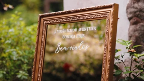 Welcome Mirror Sign With Portuguese Script at a Garden Wedding 動画素材 348330045