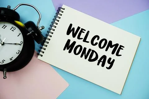 Welcome Monday text written on notepad with alarm clock flat lay on multico.. Stock Photos