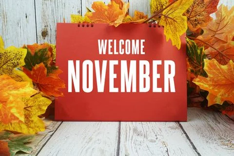 Welcome November text with maple leaf decorated on wooden background Stock Photos