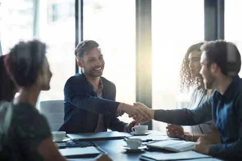 Welcome to our panel. Shot of a friendly businessman welcoming a new team member Stock Photos