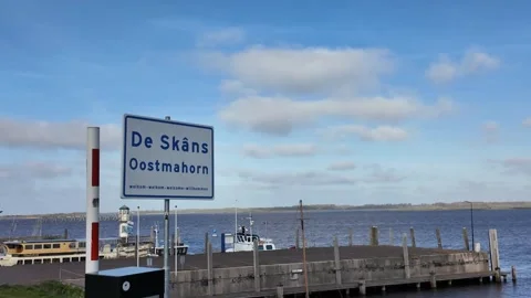 Welcome sign in multiple languages at De Skans Oostmahorn Friesland Stock Footage 336504317