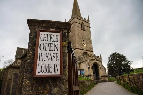 Welcome sign by path leading up to the front of a Church Foto stock