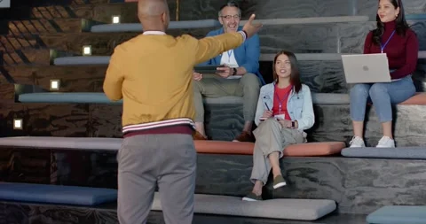 Welcome sparking male trainer gesturing, introducing group on training room Stock Footage 340610893