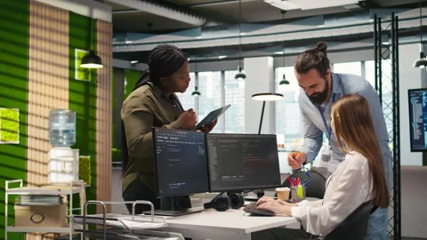 Welcoming team assisting intern developing artificial intelligence models Stock Footage 313168376