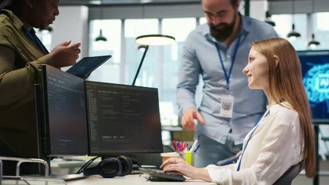Welcoming team assisting intern developing artificial intelligence models Stock Footage 313168409