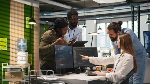 Welcoming team assisting intern developing artificial intelligence models Stock Photos