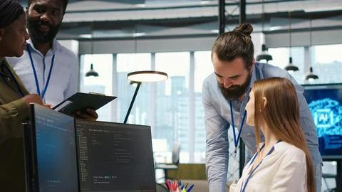 Welcoming team assisting intern developing artificial intelligence models Stock Photos