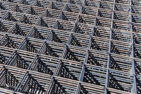 Welded mesh for the frame of a monolithic structure lies under the open sky Stock Photos