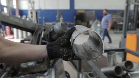 Welded seam on a section of a steel pipe with the help of a grinding machine in Stock Footage 142889806