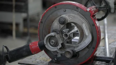 Welded seam on a section of a steel pipe with the help of a grinding machine in Stock Footage 142897459