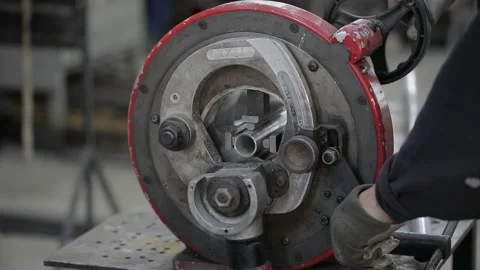 Welded seam on a section of a steel pipe with the help of a grinding machine in Stock Footage 142905087