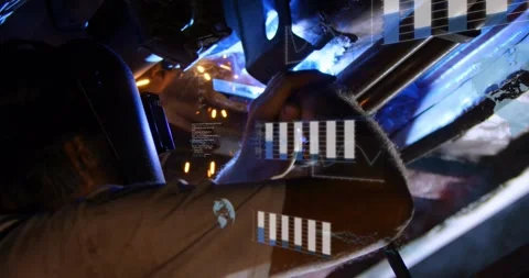 Welder activating torch and welding joint, producing sparks while HUD overlays Stock Footage 329910540