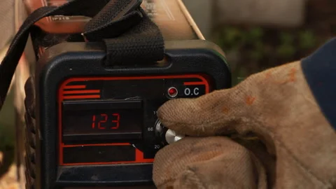 The welder adjusts the voltage supply of the welding machine Stock Footage 265199267