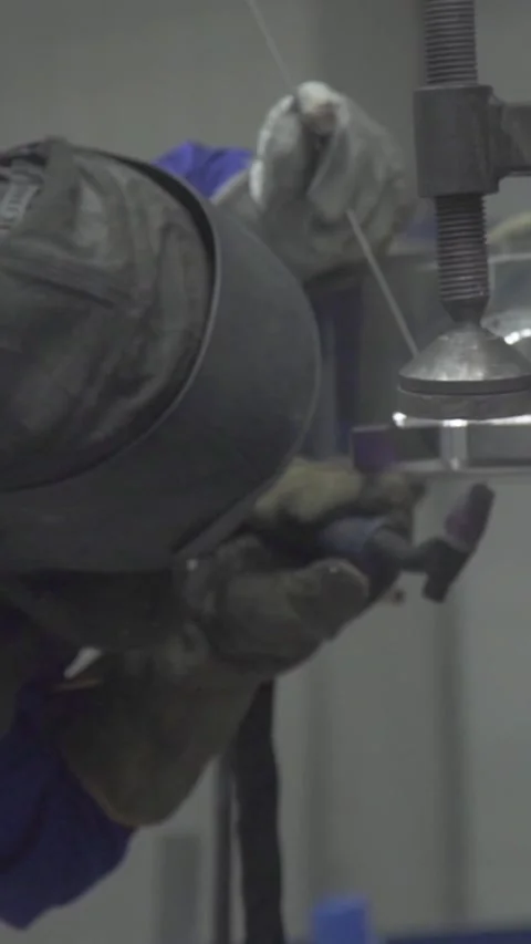 Welder Attaching Metal Part in Large Industrial Factory – Vertical Video Stock-Footage 333761313