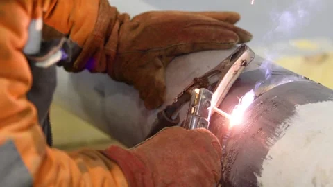 Welder at a construction site. Construction site. Welding work. Welder welding a Video stock 320021622