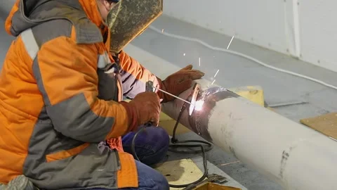 Welder at a construction site. Construction site. Welding work. Welder welding a Stock Footage 321058552