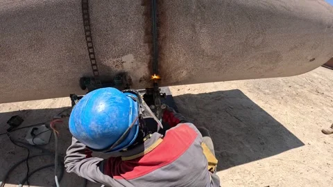 Welder at a construction site welds iron metal, 4K, 60fps Stock Footage 245302347