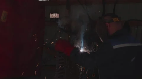 Welder cooks iron structure at construction site Stock Footage 132492704