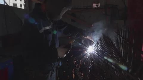 Welder cooks iron structure at construction site Stock Footage 132492858
