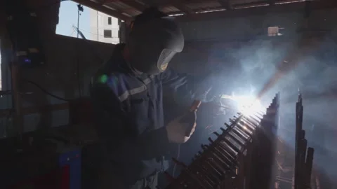 Welder cooks iron structure at construction site Stock Footage 132492902