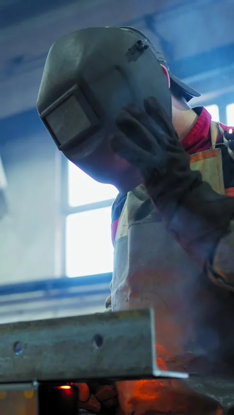 Welder creating sparks in workshop with bright blue light Stock Footage 300347926