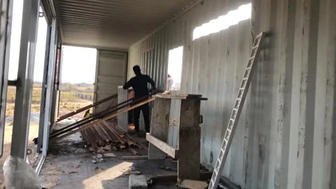 Welder cutting window marking of a shipping container, in Acrra, Ghana Stock Footage 312583833