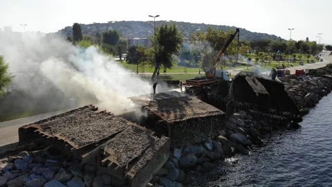 Welder disassembling sunken ship at coast at Maltepe Stock Footage 211093216