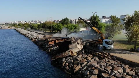 Welder disassembling sunken ship at coast at Maltepe Stock Footage 211095204