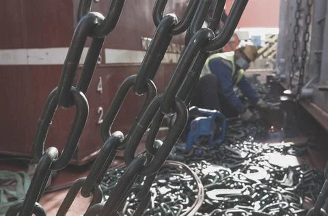 Welder doing welding on deck of ship lashing cargo Stock-Fotos