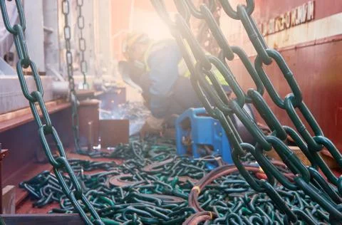 Welder doing welding on deck of ship lashing cargo Stock Photos