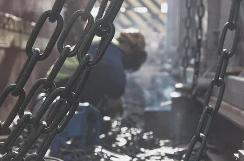 Welder doing welding on deck of ship lashing cargo Stock Photos