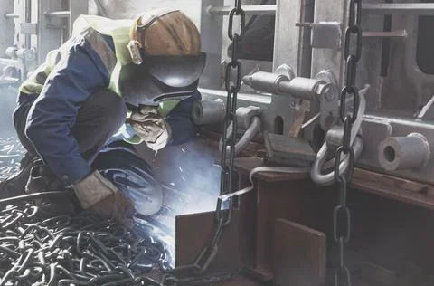 Welder doing welding on deck of ship lashing cargo Stock Photos