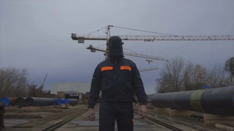 Welder In Equipment Walking Towards Camera Stock Footage 143840036