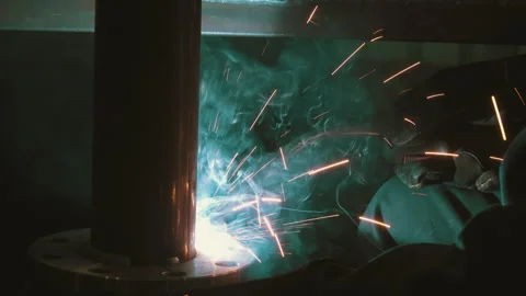Welder Fusing Steel Pipe Flange: Close-Up Industrial Welding Process with sparks Stock Footage 343901614