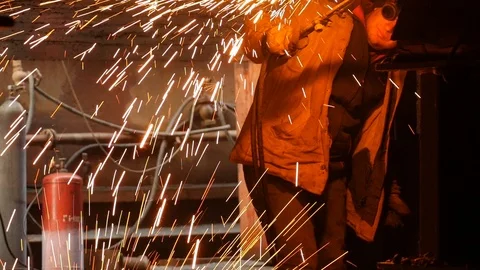 Welder with glasses, against the background of the bars, brews metal Video stock 87505337