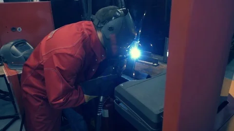 Welder is going welding of the metal profile. Sparks are flying around Stock Footage 71647379