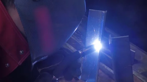 Welder is going welding of the metal profile. Sparks are flying around Stock Footage 71647728
