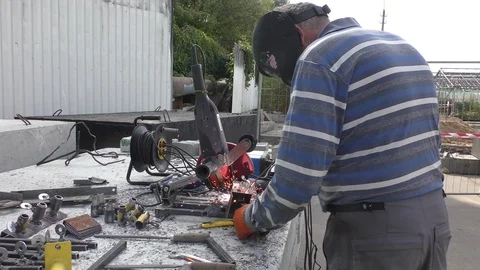 The welder having prepared the workpiece designs welds them together. Stock Footage 116130914