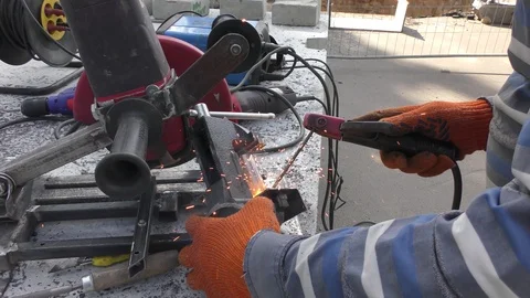 The welder having prepared the workpiece designs welds them together. Stock Footage 116149239