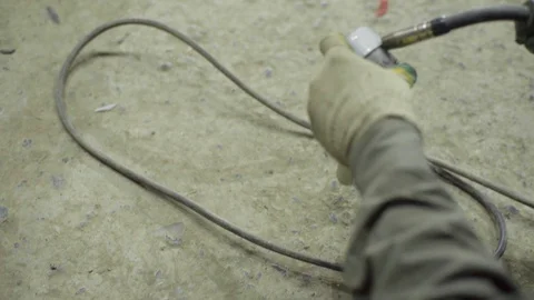 Welder joining pieces of pipe together making custom exhaust Stock Footage 128920305