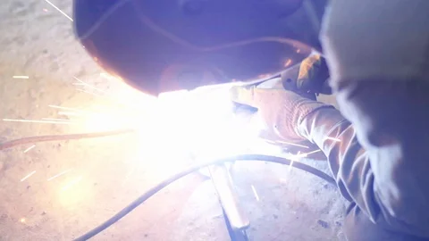 Welder joining pieces of pipe together making custom exhaust Stock Footage 128920366