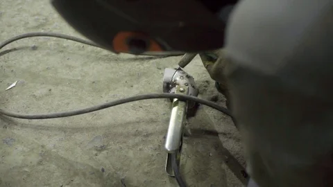 Welder joining pieces of pipe together making custom exhaust Stock Footage 128920486