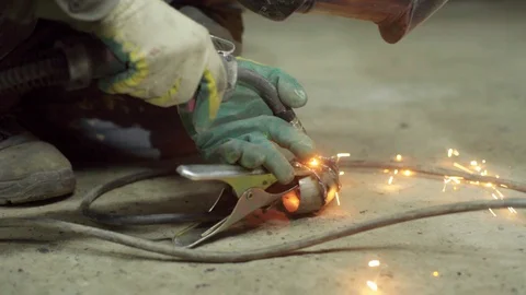Welder joining pieces of pipe together making custom exhaust Stock Footage 128920622