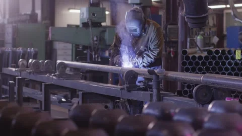 Welder Joining Steel Pipe on Rollers, Metal Fabrication Shop, Slow Motion Видео 341303301