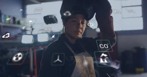 Welder lifting hand to helmet flipping visor as digital icons shifting around Stock Footage 312694902