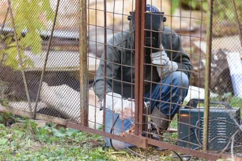 The welder makes the gate Stock Photos