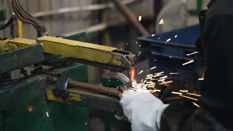 Welder makes metal products using contactless welding machine. Production of Stock Footage 250090609