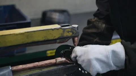 Welder makes metal products using contactless welding machine. Production of Stock Footage 250592749