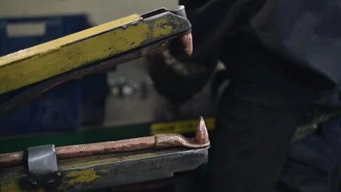 Welder makes metal products using contactless welding machine. Production of Stockbeeldmateriaal 250592770
