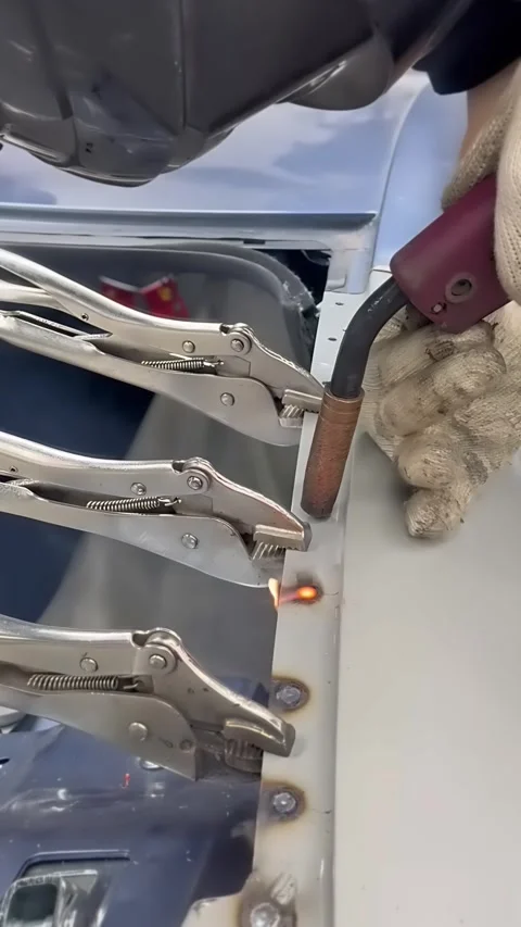 Welder Making Plug Welds on Car Body Panel With Locking Pliers Stock Footage 348691317